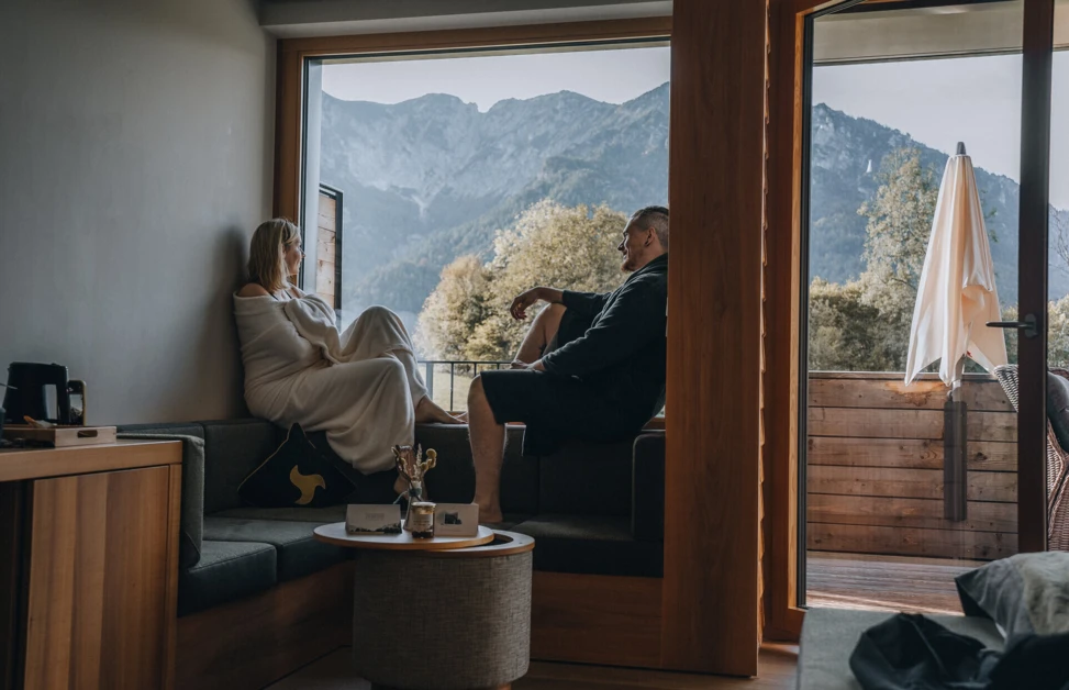 Couple relaxing in a cozy room with mountain views at Wellnesshotel Klosterhof in Bayern.