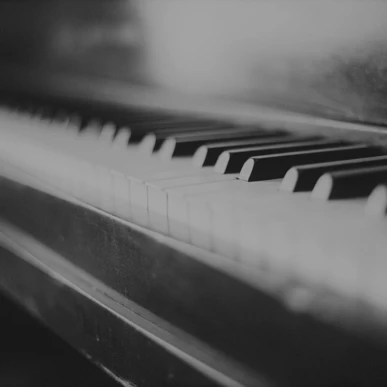 Black and white close-up of piano keys.