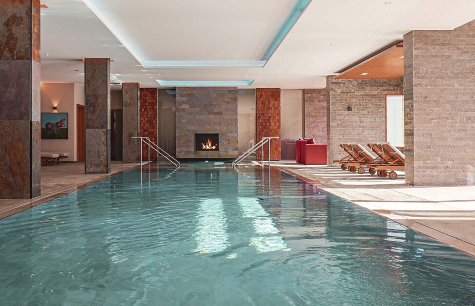 Indoor-Pool mit Ruheoasen und Kamin im Wellnesshotel Klosterhof in Bayerisch Gmain