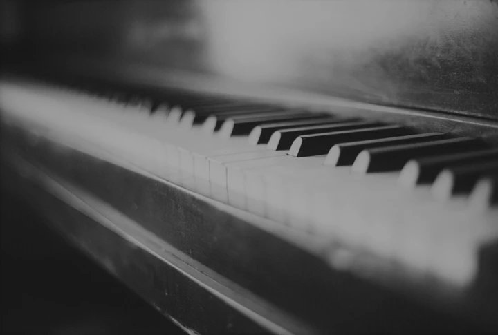 Black and white close-up of piano keys.