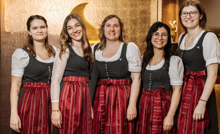 Staff in traditional attire at Klosterhof hotel.