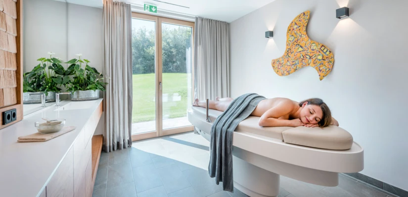 Eine entspannende Wellnessbehandlung in einem modernen Raum im Hotel Klosterhof, umgeben von natürlichem Licht und stilvoller Einrichtung.
