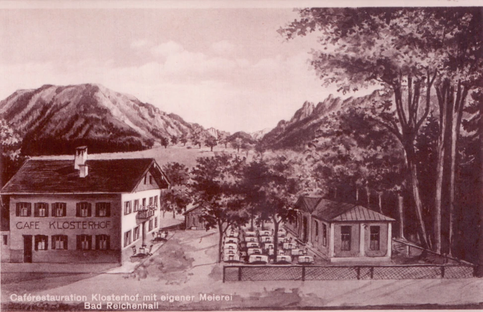 Historische Ansicht des Café Klosterhof in Bad Reichenhall, umgeben von Bergen und Bäumen.